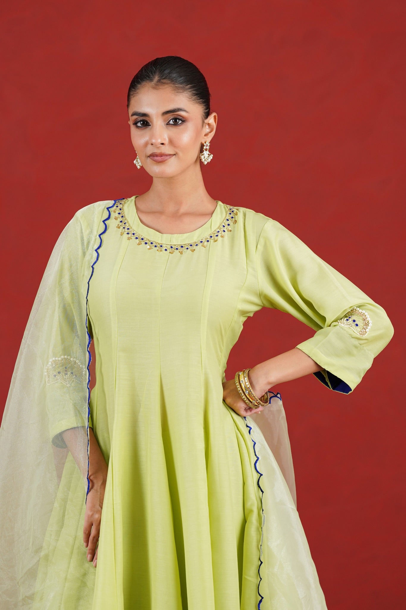 Green kurta hand embroidery neckline detail with blue and gold embellishment