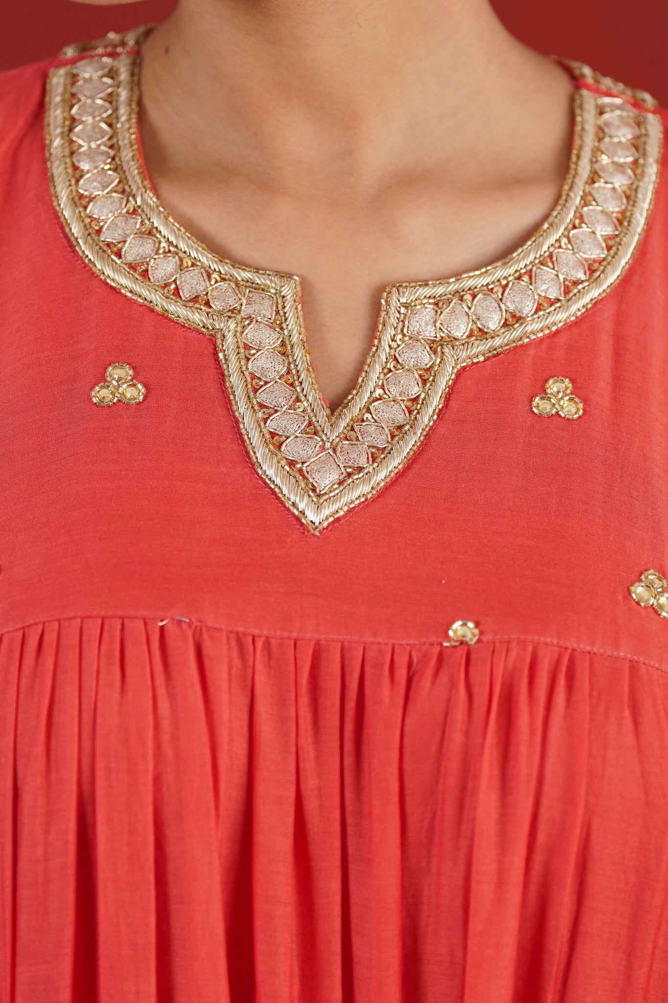 Rust red Chanderi kurta gold hand embroidered neckline - close-up